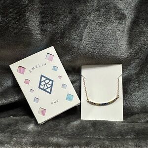 Amelia Rue Gold Tone curved rainbow necklace